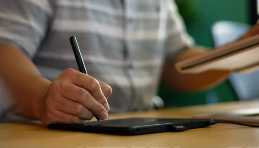 Creative team member using a stylus pen at his computer