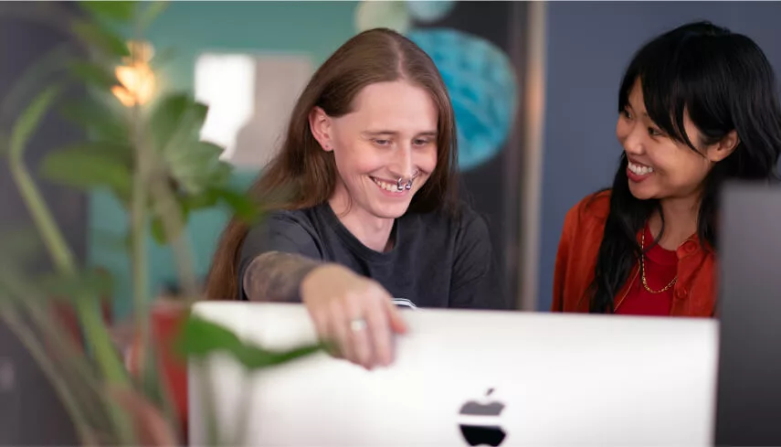 Elle and Stephanie smiling at their desks